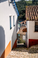 Traditional Asturian Fishing Village Architecture In Cudillero With Clay Tile Roofs And Stone Streets. Spanish Coastal Village, Cobblestone Pathways