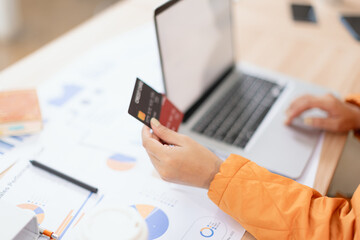 Woman Hands using Credit Card with Laptop and Online Shopping.