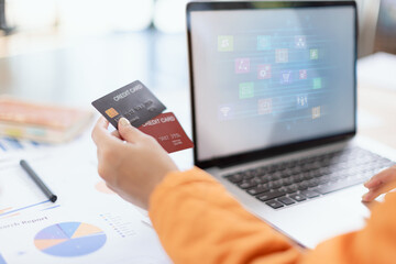 Woman Hands using Credit Card with Laptop and Online Shopping.