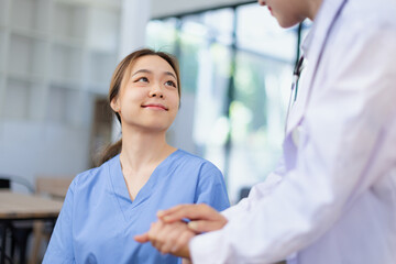 Professional encouragement, Doctor reassuring and supporting her colleague or junior staff member,...