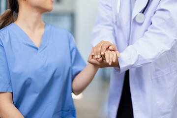 Professional encouragement, Doctor reassuring and supporting her colleague or junior staff member,...
