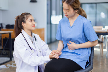 Professional encouragement, Doctor reassuring and supporting her colleague or junior staff member,...