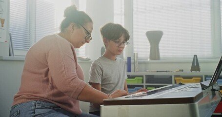 Music Teacher Guiding Primary School Boy to Play Piano in Music Class. Talented Student Practicing Keyboard Instrument, Dreaming to Become Musician. Musical Education, Piano Training Lesson, Rehearsal - Powered by Adobe