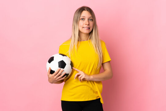 Young football player woman isolated on pink background having doubts and with confuse face expression - Powered by Adobe