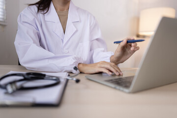 Medical professional using a computer for online patient support, Medical professional and Healthcare technology Concept.