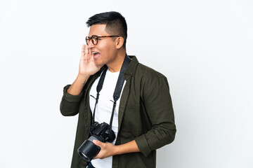 Fototapeta premium Young Ecuadorian photographer isolated on white background shouting with mouth wide open to the side