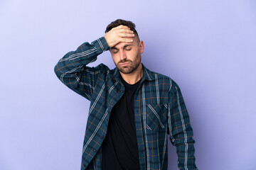Caucasian man isolated on purple background with headache