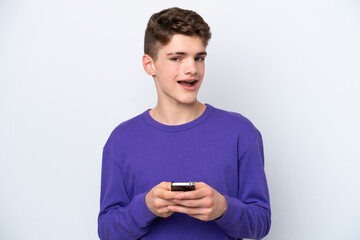 Teenager Russian man isolated on white background surprised and sending a message