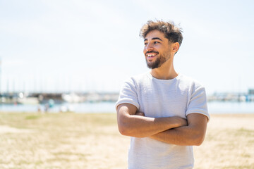 Handsome Arab man at outdoors happy and smiling