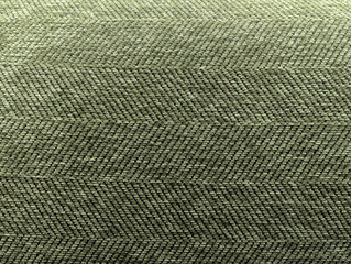 Polister. The close-up of a fabric with a distinct texture with a prominent herringbone pattern