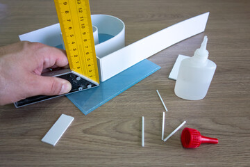 Production of outdoor advertising.A second-hand glue for plastic.Advertising workshop.Metal ruler...