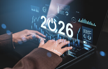 Futuristic digital interface showing 2026 with business data charts and hands typing on keyboard, symbolizing future technology and innovation concept.