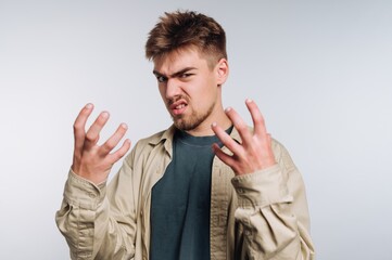 Fototapeta premium Young man expressing frustration with hands raised