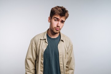 Young Man with Skeptical Expression in Casual Attire