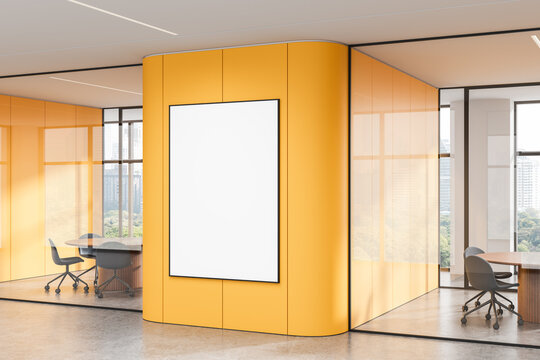 Vertical poster mockup on yellow wall in modern office with glass partitions and city view through windows, perfect for branding or design showcase. 3D Rendering