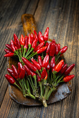 Hot chilies bundled on a dark wooden background