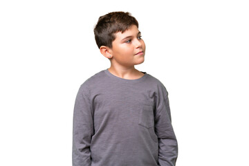 Fototapeta premium Little caucasian kid over isolated chroma key background looking to the side