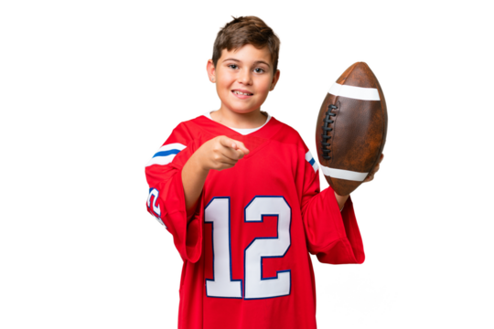 Little caucasian kid playing rugby over isolated chroma key background points finger at you with a confident expression