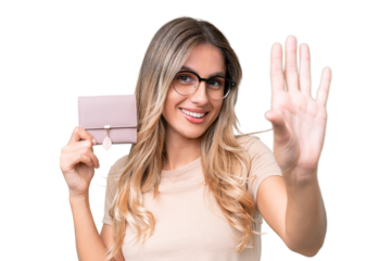 Young Uruguayan woman holding a wallet over isolated background saluting with hand with happy expression