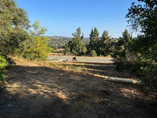 overlooking an empty street through the mountainous forest - Escondido, California, USA