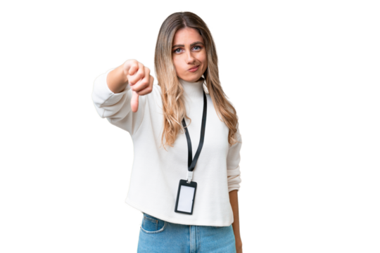 Young Uruguayan woman with ID card over isolated background showing thumb down with negative expression