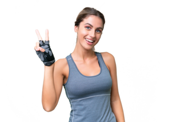 pretty Sport Uruguayan woman over isolated background smiling and showing victory sign