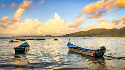 Two fishing boats in a fishing bay at sunset. Landscape for travel, advertising, screensavers, and typography.