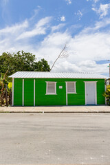 Pedernales, Dominican Republic, 8 august 2025. Typical Dominican Caribbean house made of wood, painted a bright green color.