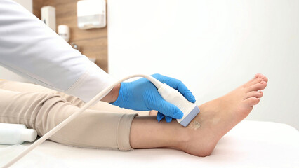 Ultrasonic of ankle joint. Sonographer checking patient ankle using high-frequency sound waves of ultrasound machine