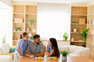 Family bonding over creative activities in a bright, cozy living room