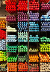 Display of colorful pencils - art supplies in a shop window inside small square boxes