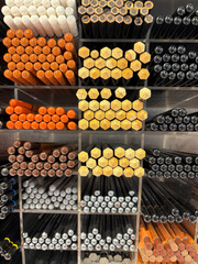 Beige and brown pencils - stationery and art supplies in small square boxes on the wall