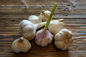 Garlic cloves stylised on weathered wooden boards