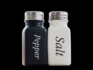 Salt and Pepper Shaker Duo On Black Background: Modern Kitchen Table Setting and Condiments