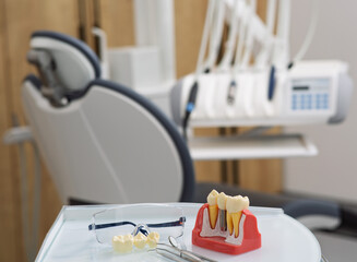 A dental chair and tools await a patient in a contemporary stomatology office, emphasizing dental care and health