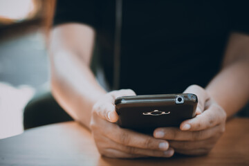 a person holding a smartphone with both hands, with a dark screen displaying, network connections visualized