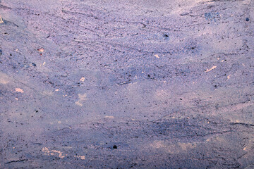 
textured background of plaster with blue streaks on pink