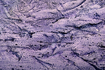 
textured background of plaster with pink and blue streaks