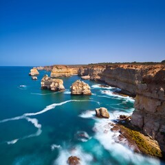 Obraz premium Australian coastline with cliffs and rock formations on a sunny day with blue sky and ocean waves