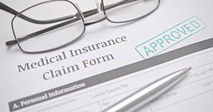 Health Insurance Claim Form with Approved Stamp and Pen