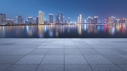 Modern City Skyline at Night Reflecting on Water