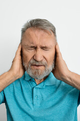Headache, stress. Senior man with headache touching hands on temples with suffering facial and eyes closed. Migraine