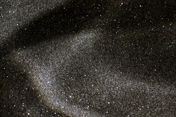 Obraz premium Abstract black sparkles grainy background with sunlight shadow template with copy space. Christmas, Halloween,holiday backdrop, wallpaper.