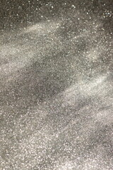 Abstract background silver grainy with sunlight shadow template with copy space . Christmas background .Abstract black sparkle texture.