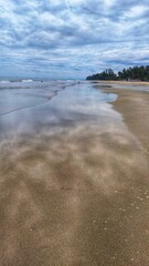 Mirror-like shoreline with retreating waves