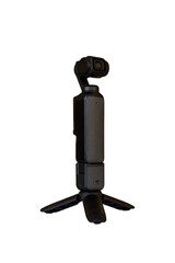 Compact Handheld Gimbal Camera Mounted on Mini Tripod on Wooden Table with Blurred Background.