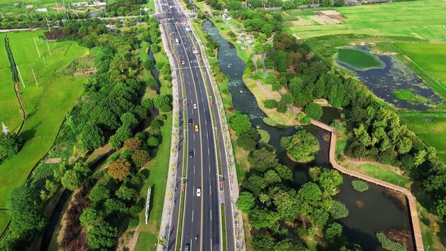 Aerial Drone Journey Over City Streets, Canals, Rice Fields, Parks and Countryside