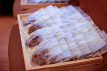 soft cookies in plastic packaging, neatly arranged on a wooden tray
