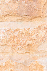 Beautiful stone wall laying in light sand color. natural stone texture. A sample of building material for walls. A copy space. Abstract background