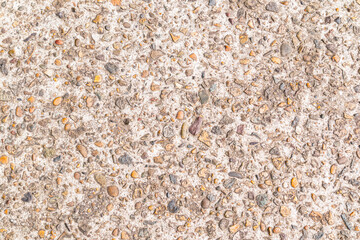 Abstract cement surface background with small fragments of natural stone. Beige is a light natural texture color. A copy space. layout for design.